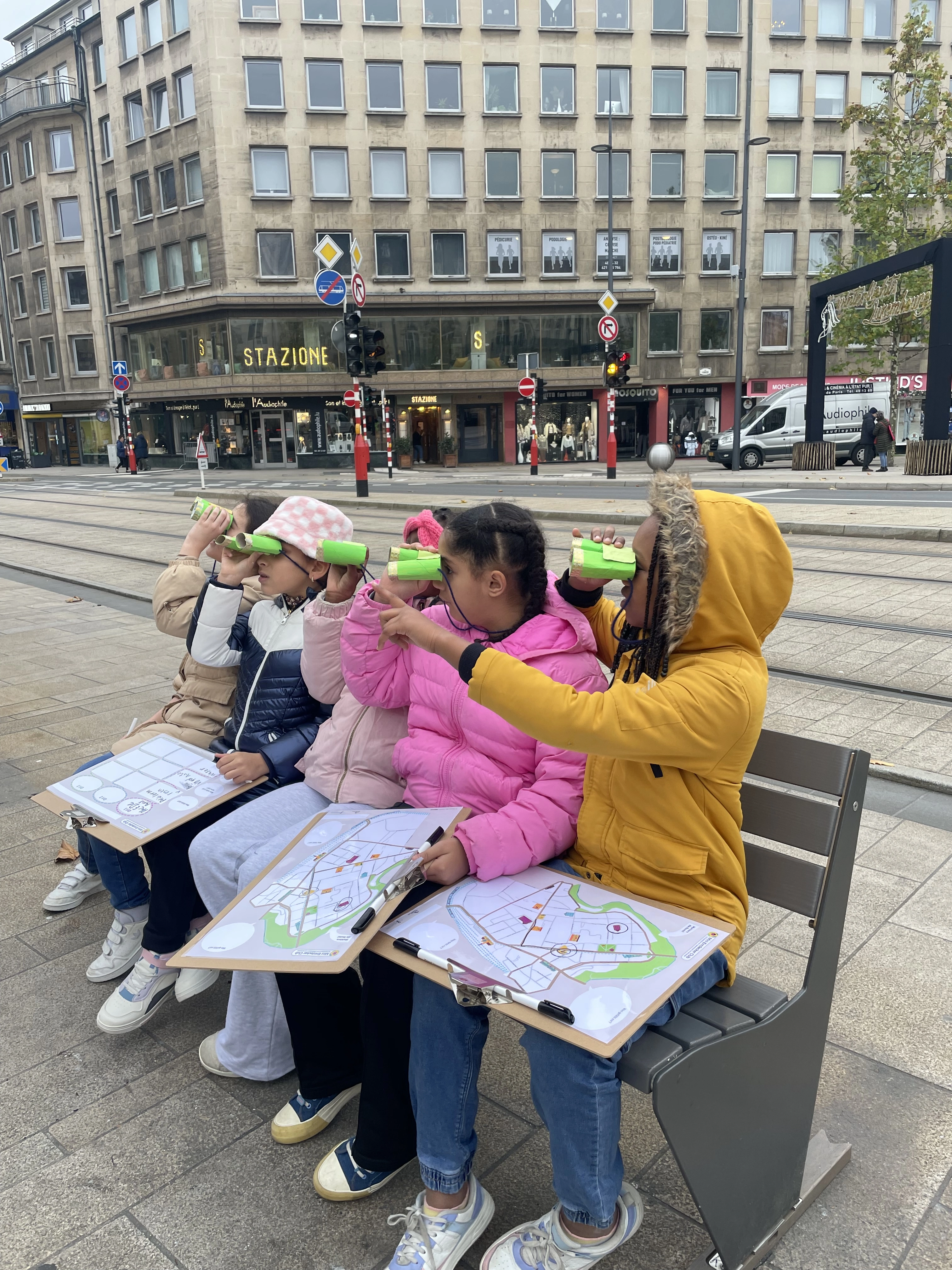 children playing city exploration game with selfmade spyglasses